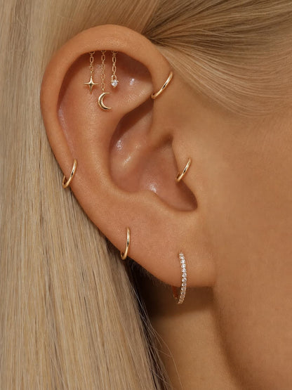 925 sterling silver celestial hidden helix stud worn on ear with star moon and dangling charm details