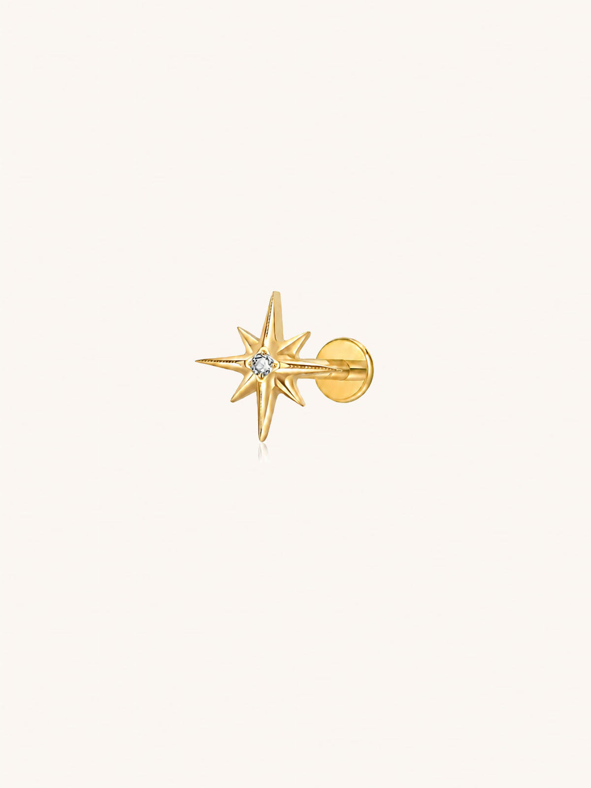 Gold G23 titanium starburst flat back stud with clear zirconia for helix lobe and cartilage piercings