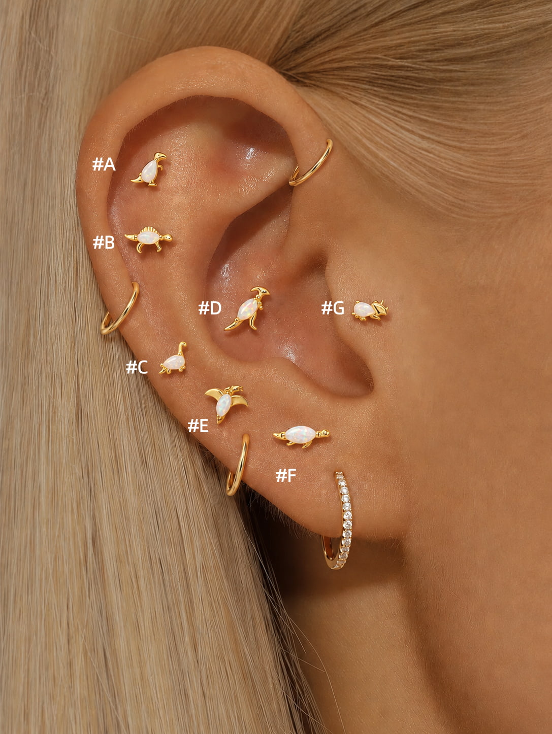 Opal dinosaur 925 sterling silver flat back earrings shown in an ear stack with seven styles labeled A through G