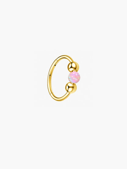 Gold G23 titanium seamless clicker ring featuring a pink opal center bead and polished ball accents