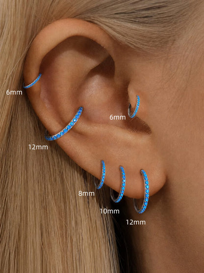Blue opal clicker ring size comparison showing 6mm 8mm 10mm and 12mm on the ear