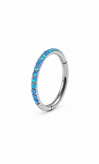 Blue opal G23 titanium hinged clicker ring on a white background
