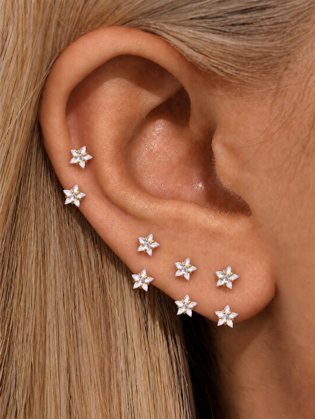 Clear double star horseshoe rings worn on multiple cartilage and lobe piercings