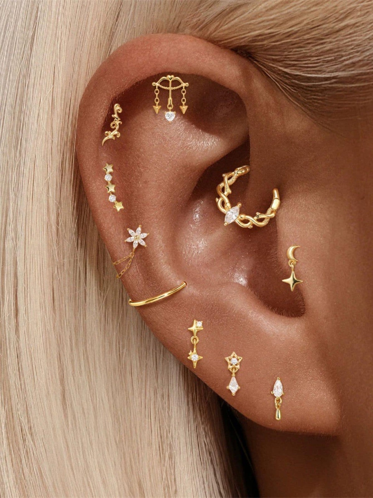 Cupid heart and arrow hidden helix stud styled in a gold curated ear stack