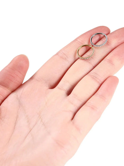 Gold and silver freshwater pearl clicker hoop rings shown on hand