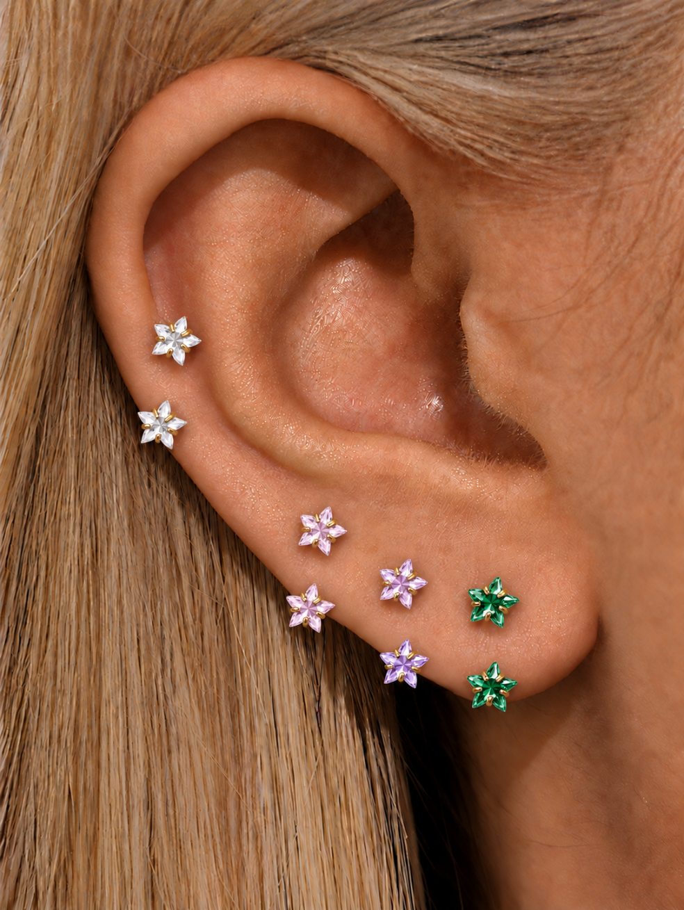 G23 titanium star horseshoe rings in clear pink purple and green styled in an ear stack
