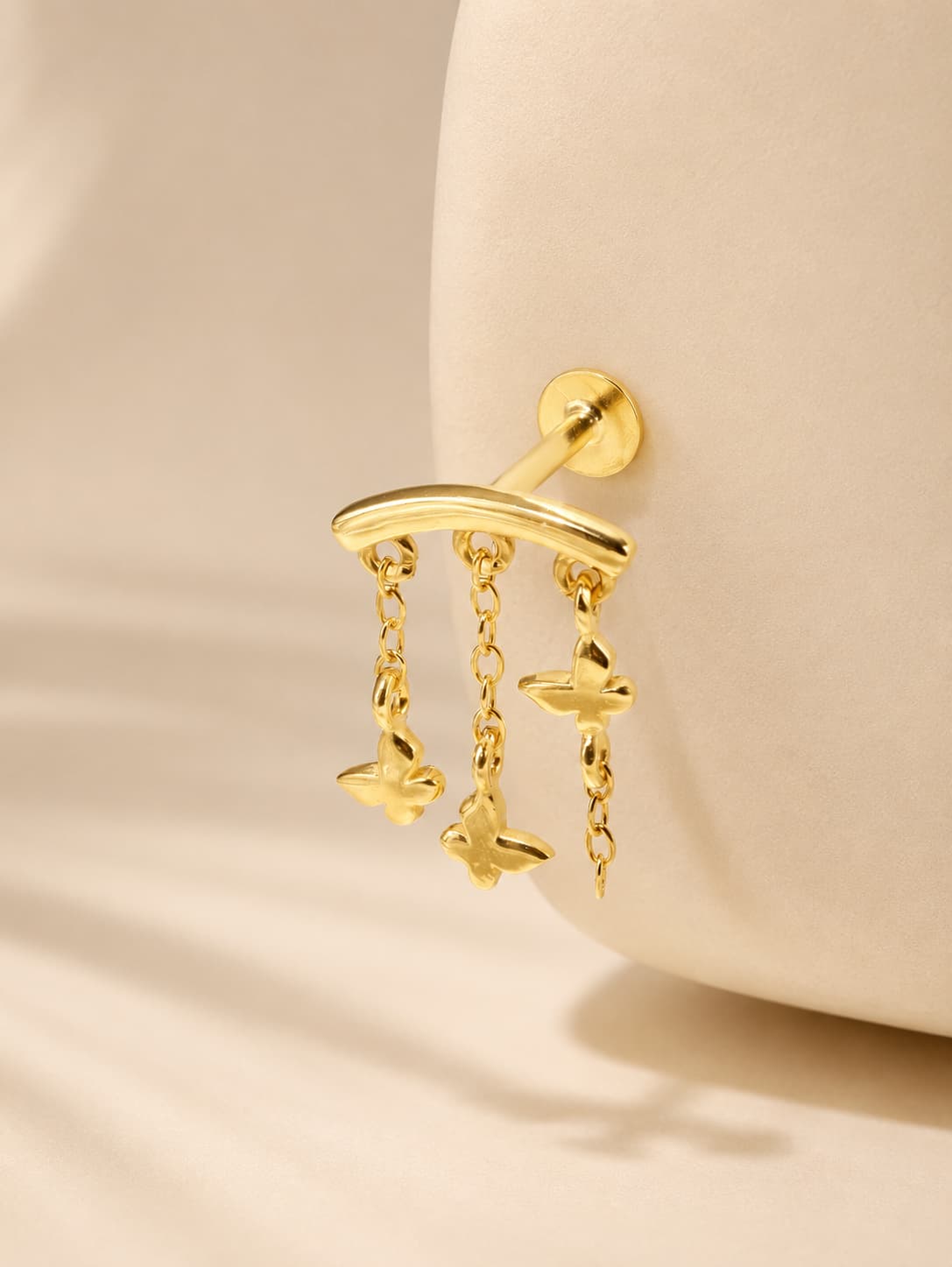Gold butterfly hidden helix stud in 925 sterling silver with three dangling chain charms