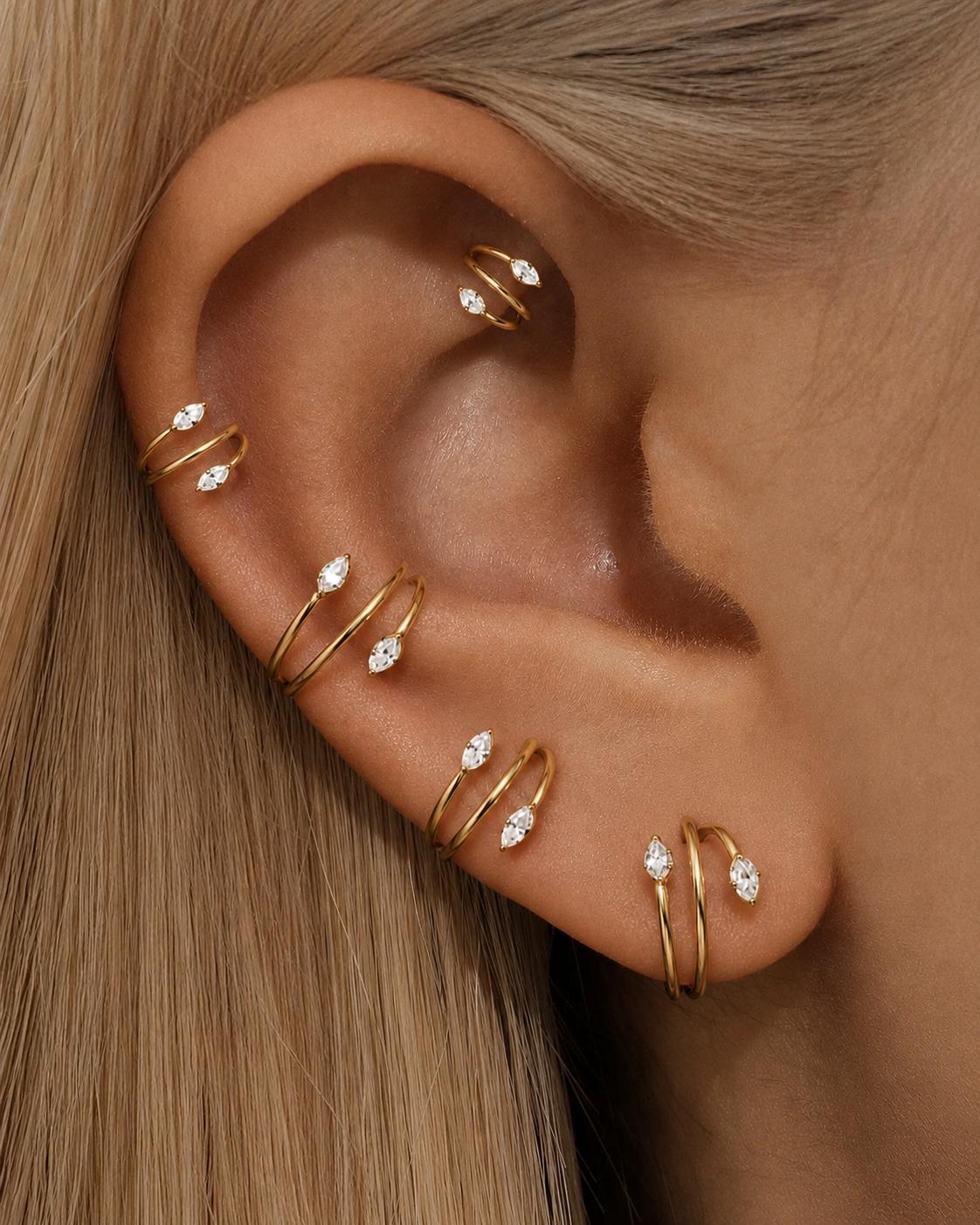 Gold marquise CZ double clicker hoops worn in a cartilage ear stack