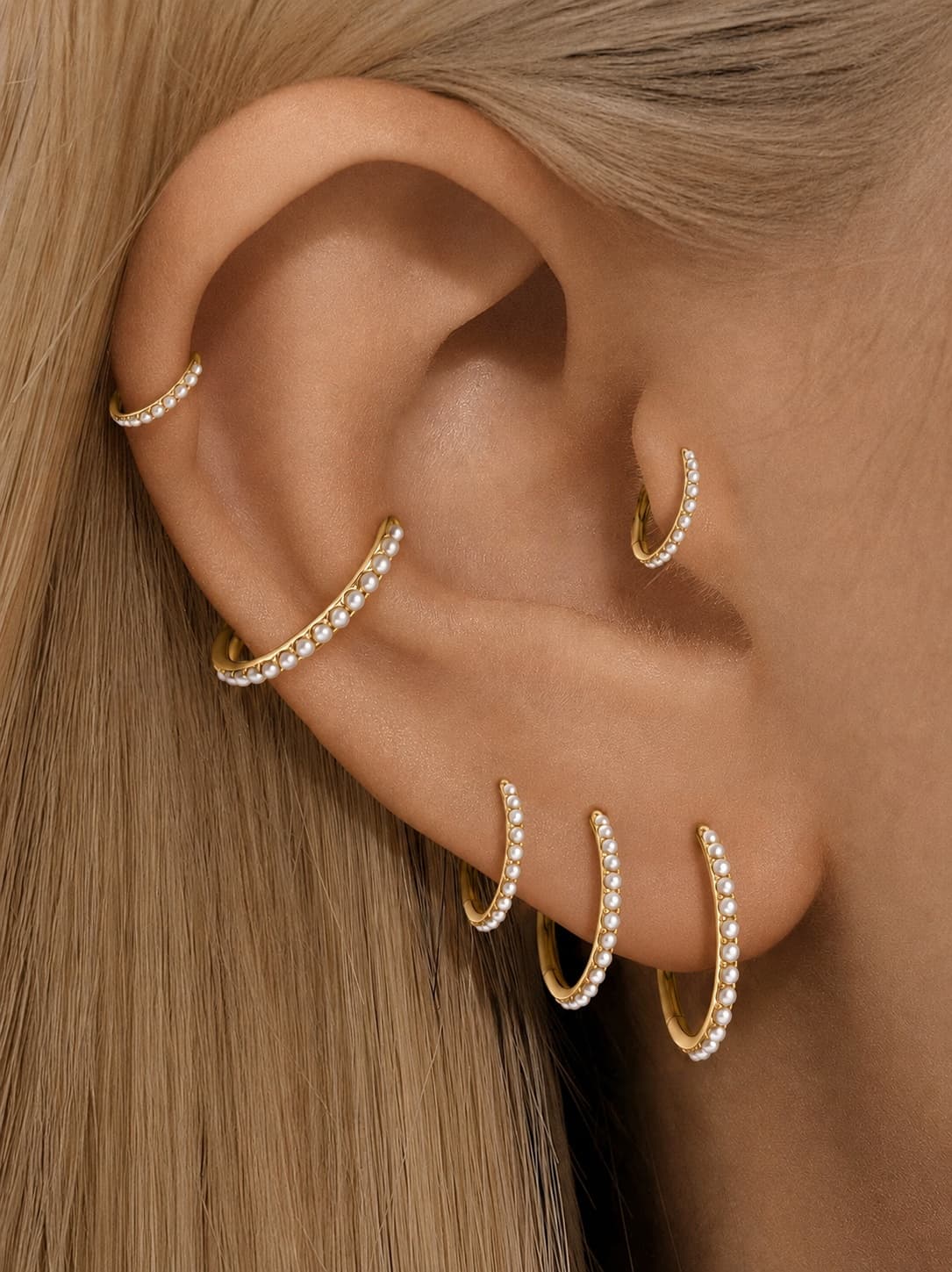 Gold freshwater pearl clicker hoops styled on helix conch lobe and tragus piercings