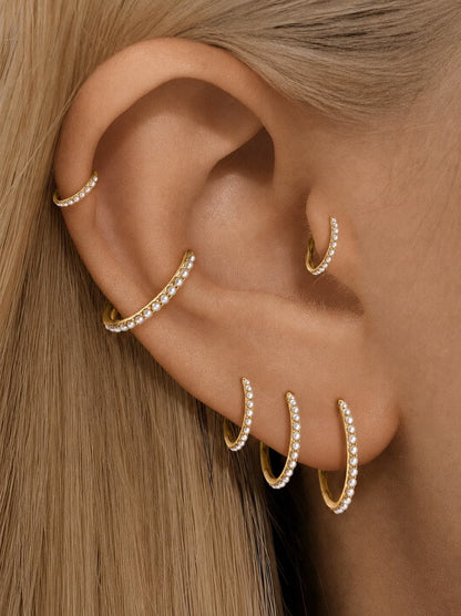 Gold freshwater pearl clicker hoops styled on helix conch lobe and tragus piercings