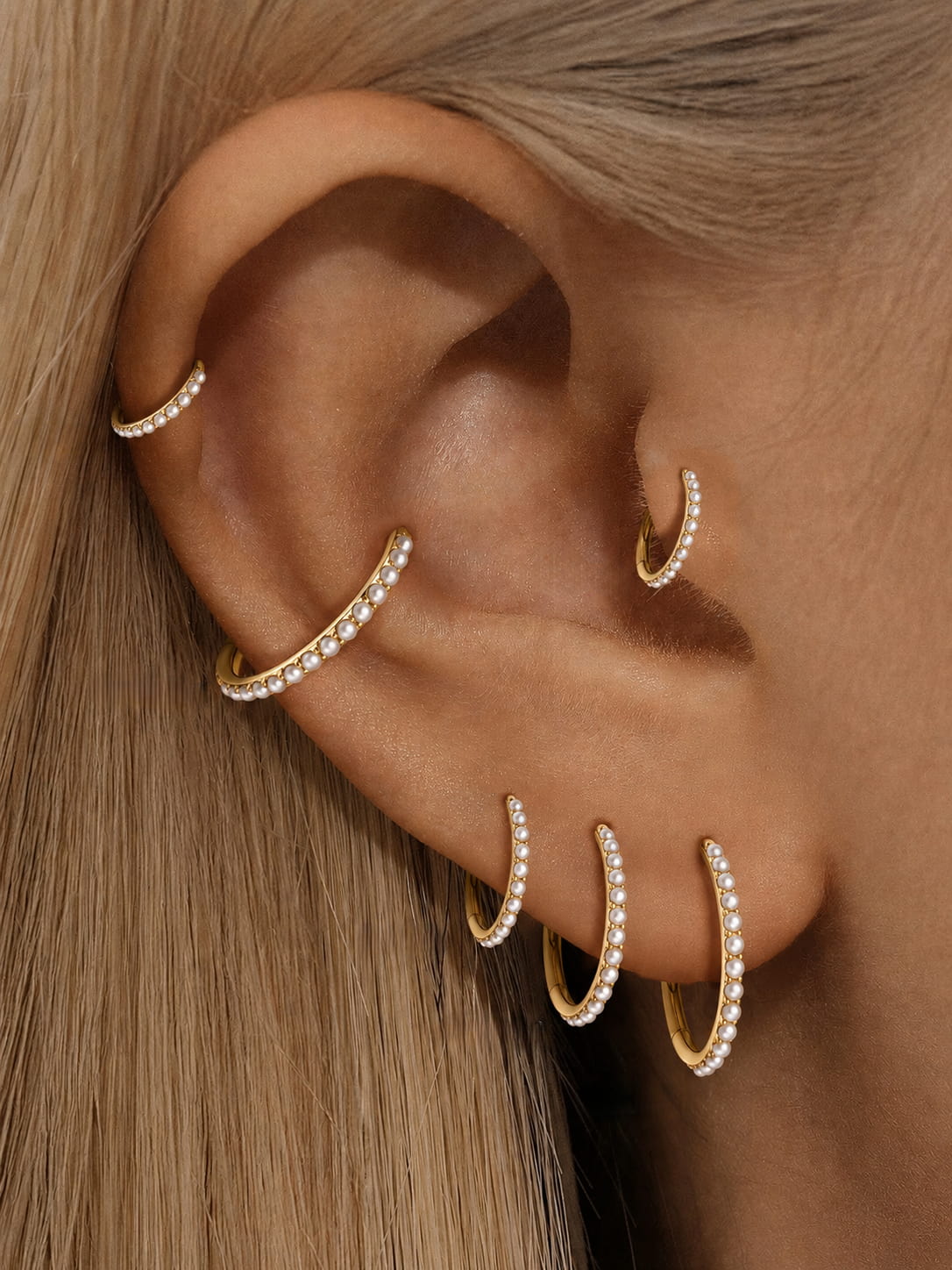 Gold freshwater pearl clicker hoops styled on helix conch lobe and tragus piercings