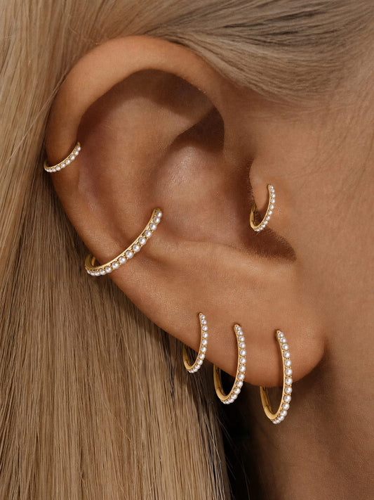 Gold freshwater pearl clicker hoops styled on helix conch lobe and tragus piercings