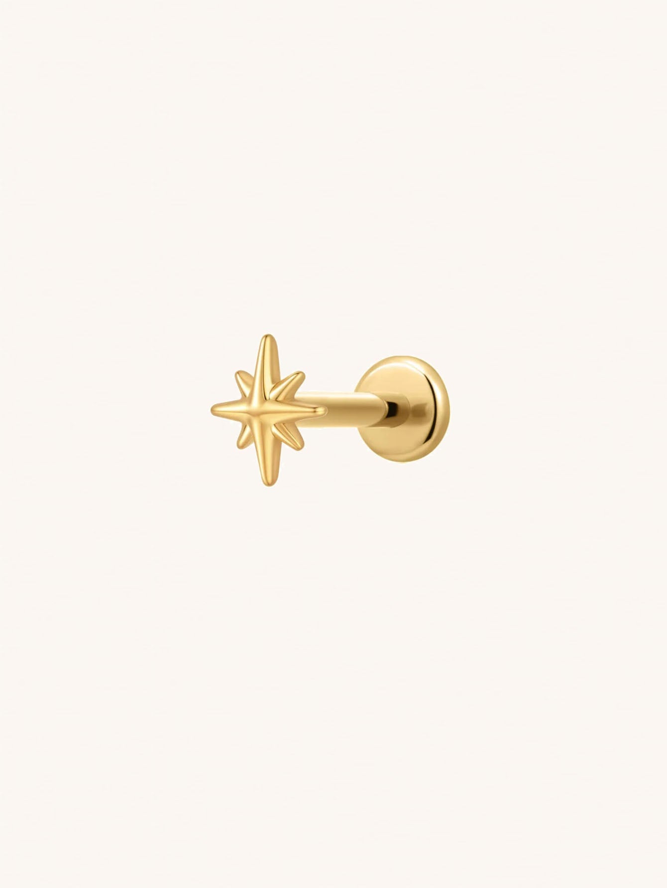 Gold eight point star threadless flat back stud in G23 titanium for cartilage piercings