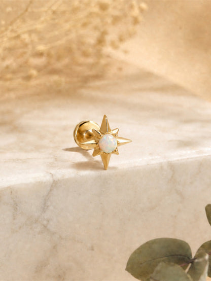 Gold opal star flat back earring displayed on marble background