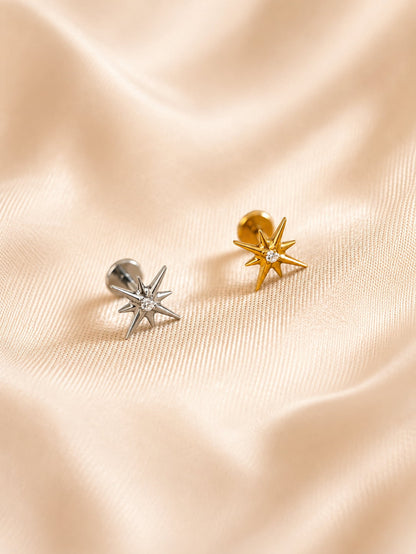 Gold and silver G23 titanium star flat back studs on satin background