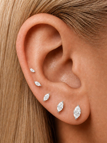 Marquise moissanite flat back studs styled in graduated sizes on the ear