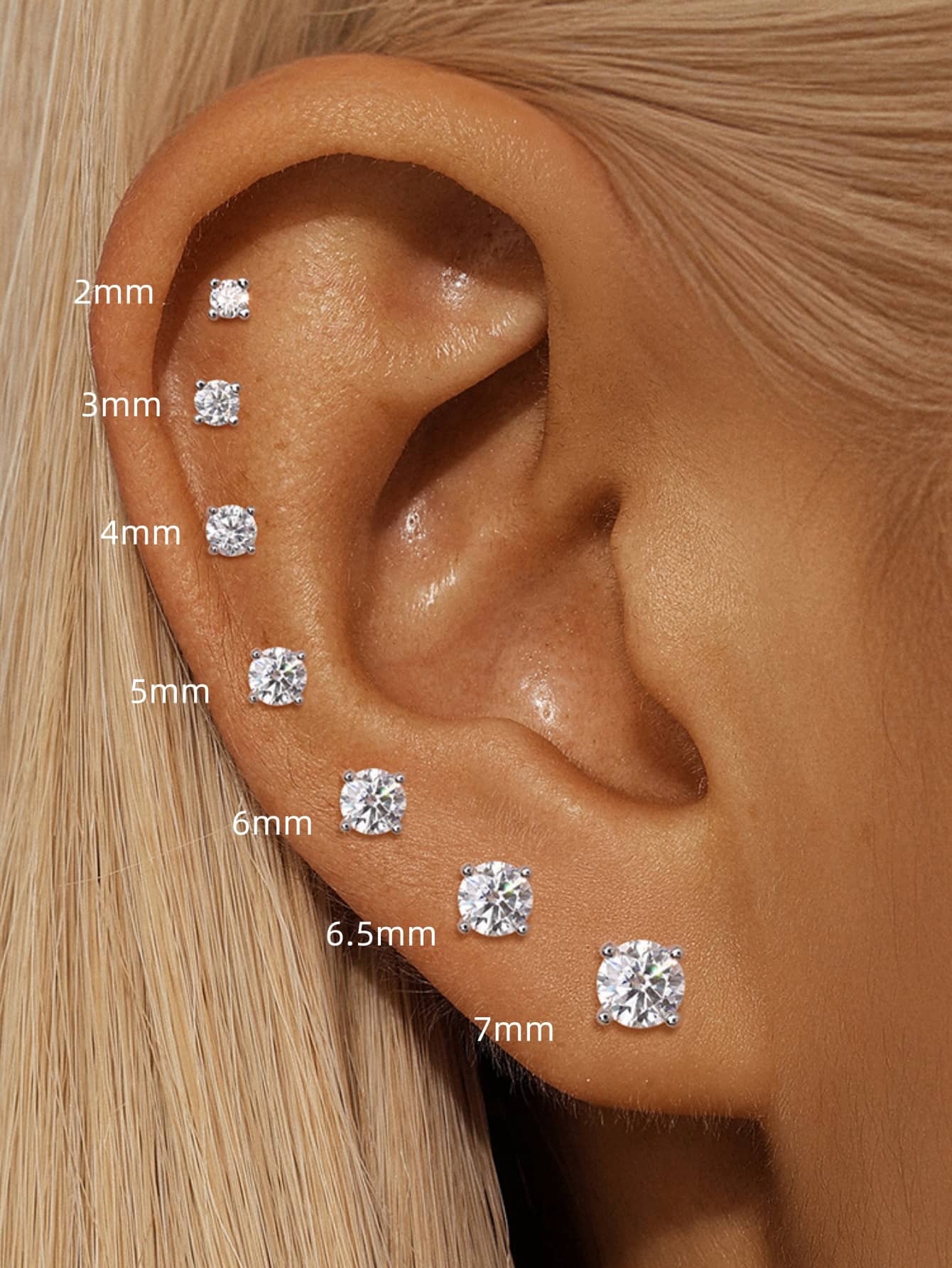 925 sterling silver moissanite flat back studs shown in 2mm to 7mm sizes on ear