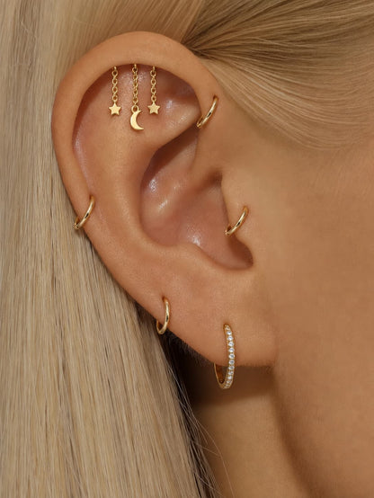 Gold moon and star hidden helix earring styled on upper ear