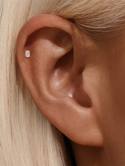 Opal flat back stud earring worn on helix cartilage piercing