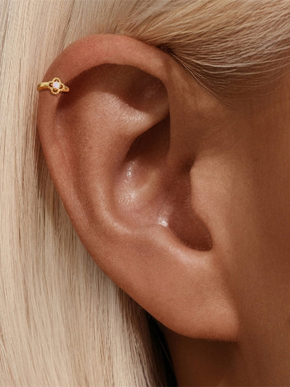 Opal flower clicker hoop earring worn on helix cartilage piercing
