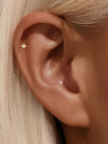Opal star flat back earring worn on helix cartilage piercing
