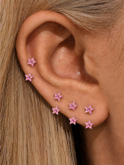 Pink double star horseshoe rings styled on cartilage and lobe piercings