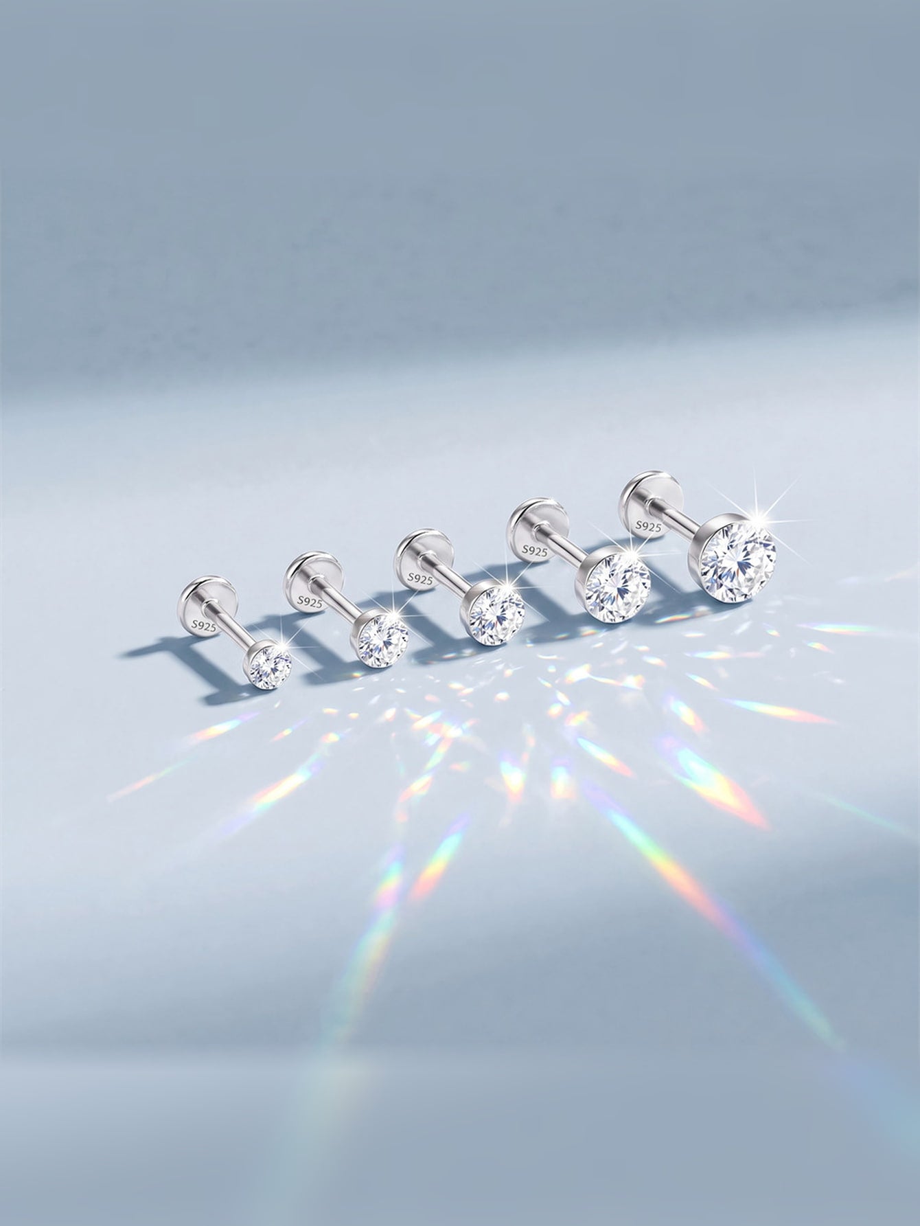 Round moissanite flat back studs showing brilliant light reflection