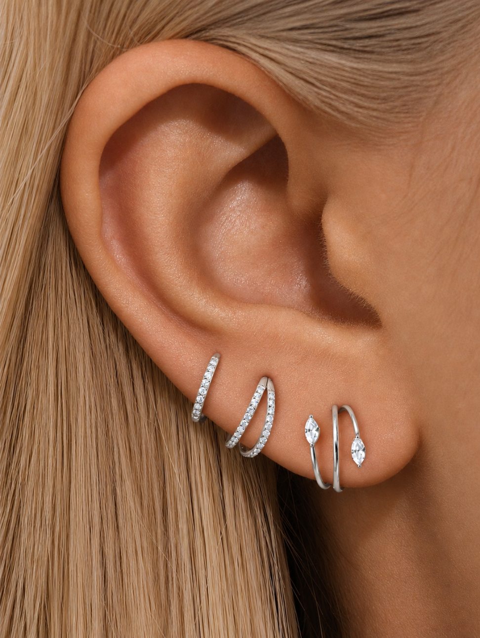 Silver G23 titanium CZ 3-piece ear stack styled on multiple lobe piercings