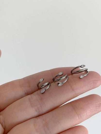 Silver marquise CZ titanium clicker hoops displayed in three sizes