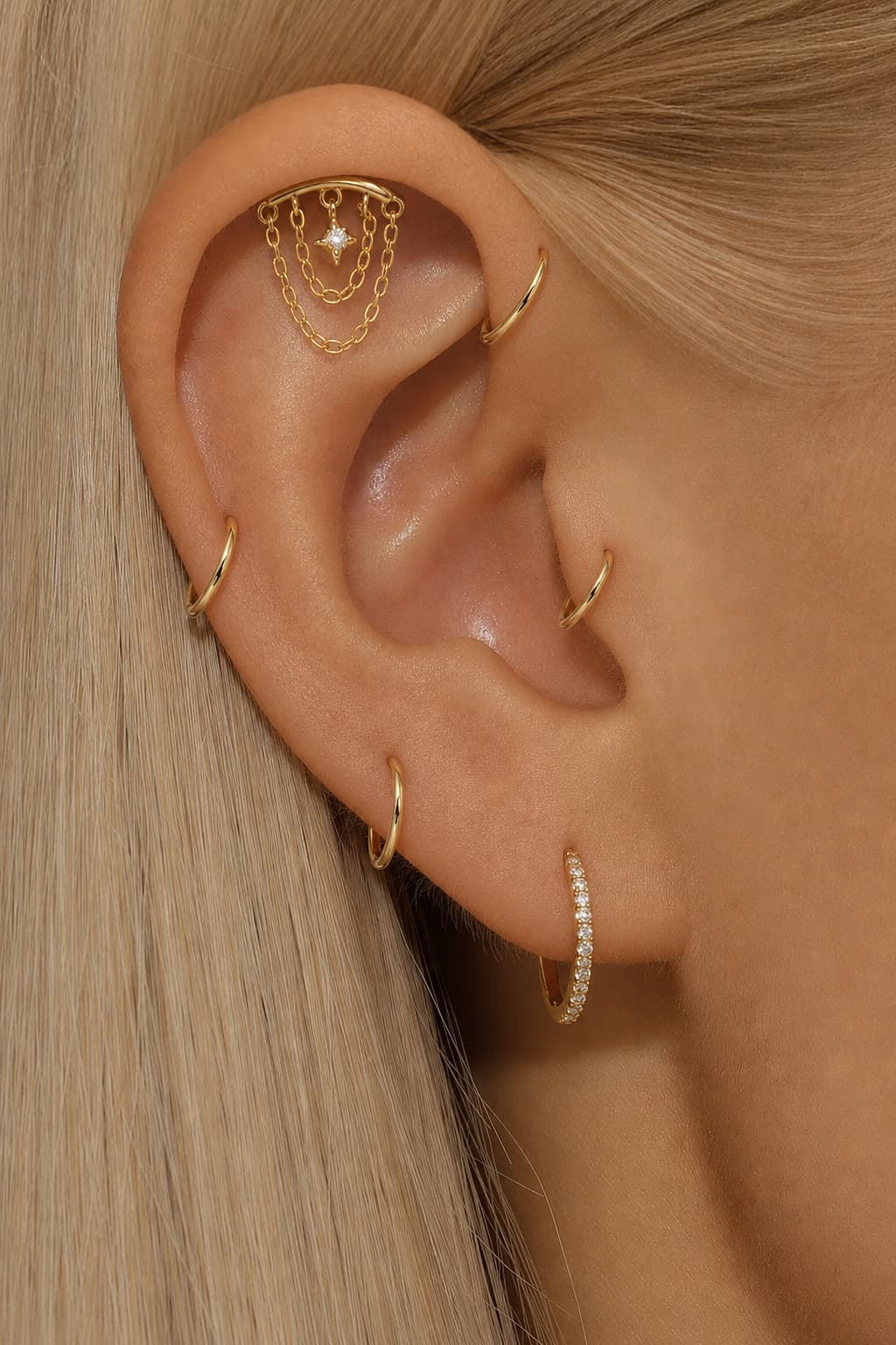 Gold star chain hidden helix earring styled on upper ear