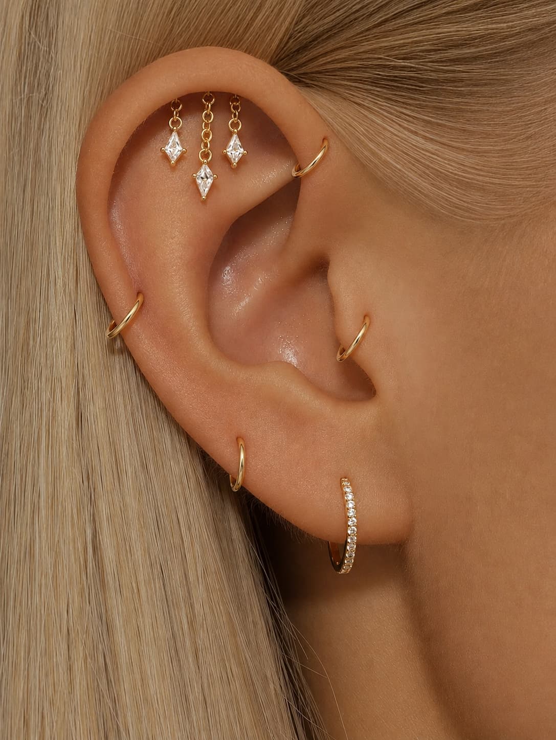 Triple dangle hidden helix stud worn on the upper ear with geometric stone charms