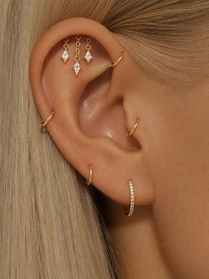 Triple dangle hidden helix stud worn on the upper ear with geometric stone charms