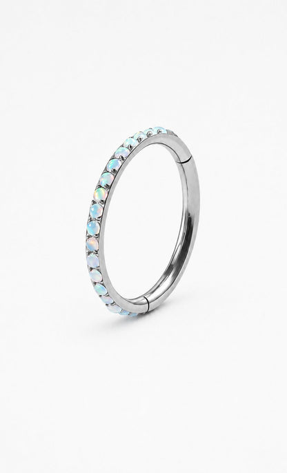 Blue opal G23 titanium hinged clicker ring on a white background